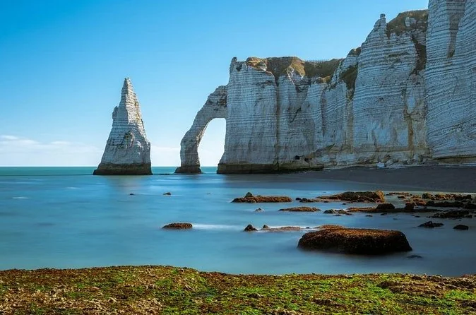 The Aiguille needle and the Porte d'Aval arch in calm blue water