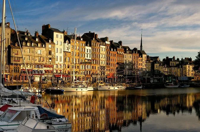 Honfleur's harbour houses and moored boats in warm golden-hour light